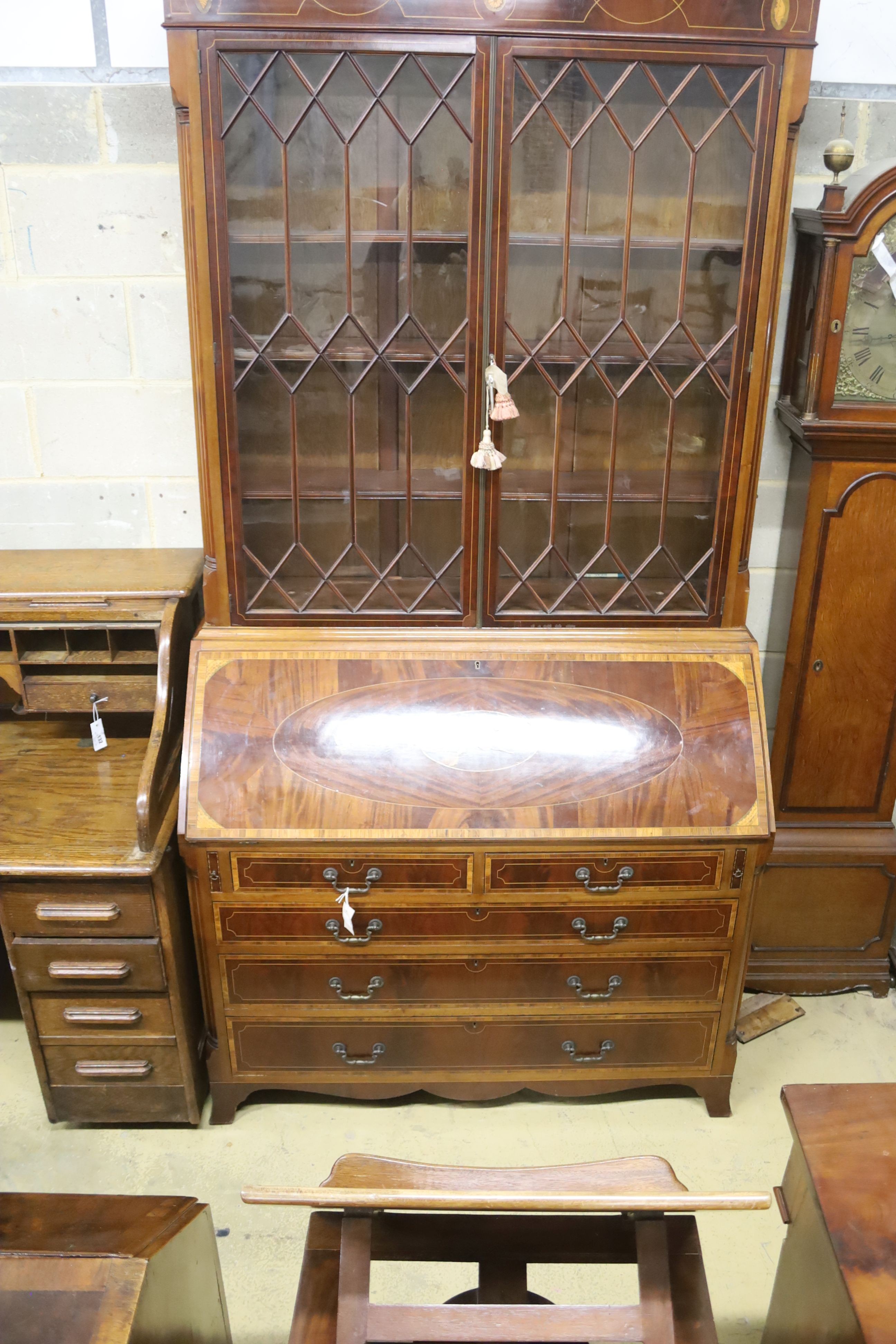 A George III style inlaid mahogany bureau bookcase, length 132cm, depth 57cm, height 276cm